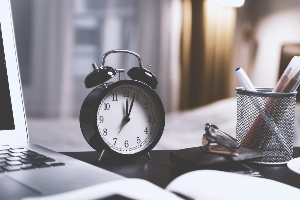 Analog clock on desk to highlight the title "Tick-Tock"